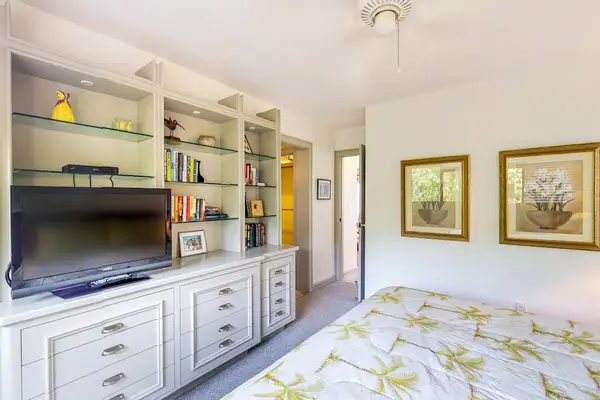 Cozy Bedroom with Large Built-In Media Center & TV