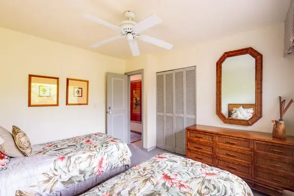 Guest Bedroom with Twin Beds, Ample Closet Space, & Large Dresser Mirror