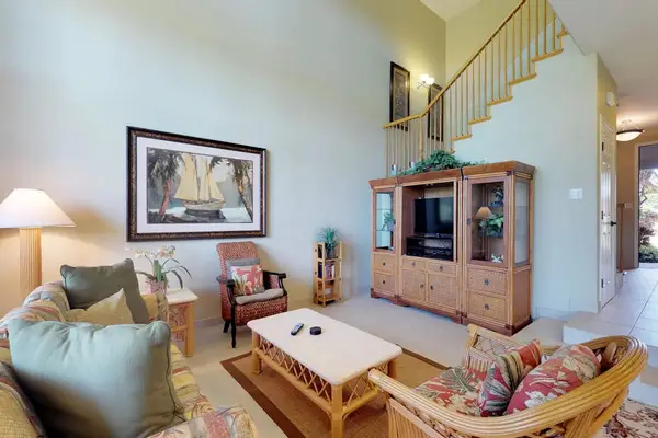 Spacious High-Ceiling Living Room with Plush Seating
