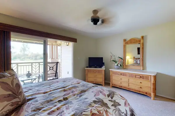 Primary King Suite with Sliding Glass Doors & Wooden Dresser