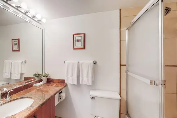 Full bathroom with a spacious vanity and tub-shower combination