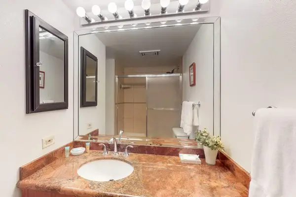Full bathroom with generous vanity space and bright lighting