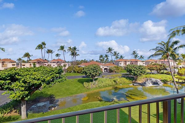 Elevated Balcony View Overlooking Resort Lawns, Palm Trees & Scenic Water Feature