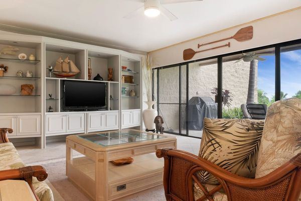 Bright Living Area with Large Windows & Media Center