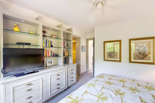 Cozy Bedroom with Large Built-In Media Center & TV