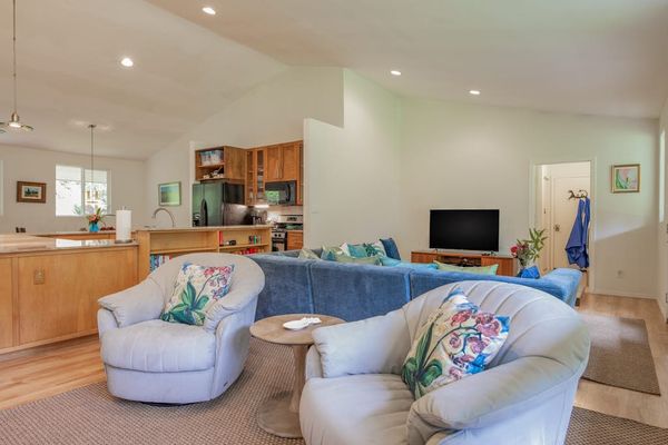 Sunlit Living Room with Plush Swivel Armchairs