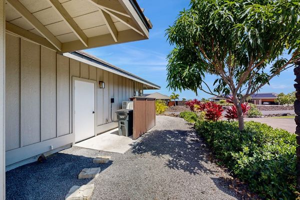 Side Exterior Pathway with Gravel Walk, Utility Area & Landscaping