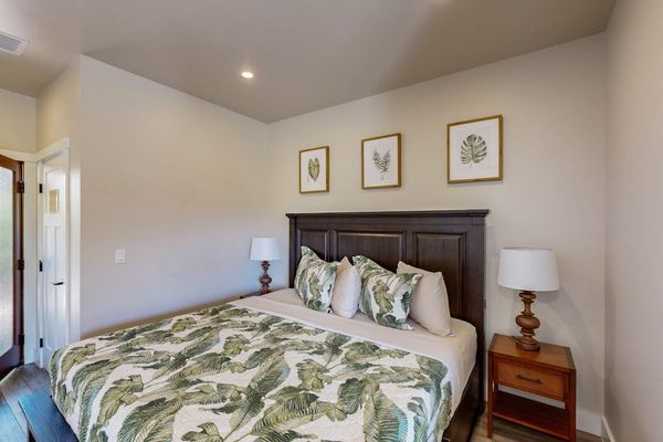 Warmly Lit Bedroom Nook with Dark Wood Headboard & Side Tables