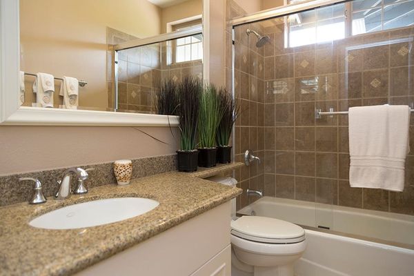 Guest Bath featuring Granite Vanity & Tub/Shower Combination