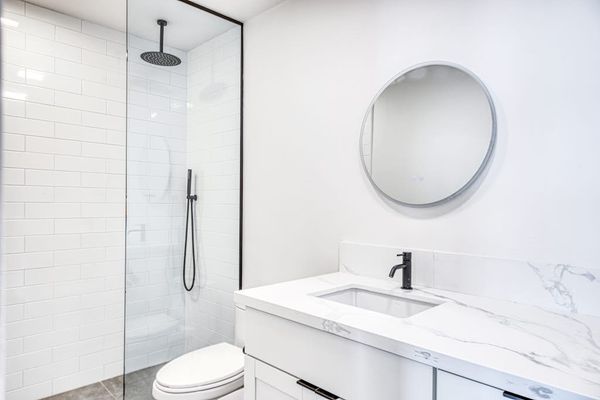 Sleek Round Mirror Accents Complement A Bright Clean Space
