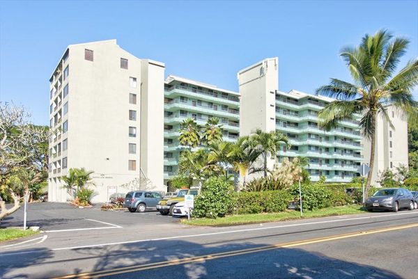 Welcoming Condo Exterior Surrounded By Palms