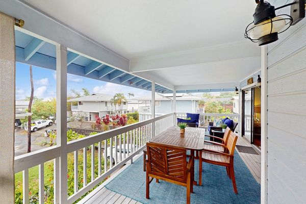 Beautiful covered balcony featuring a wooden dining set, stylish outdoor rug, and bright open-air layout for ultimate relaxation! 🍽️✨