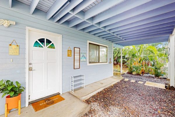 Charming front entrance featuring a covered porch, beautiful blue accent beams, and a welcoming front door setup! 🏠✨