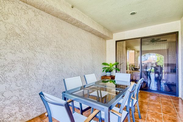 Al fresco dining area offers comfortable seating beneath covered lanai