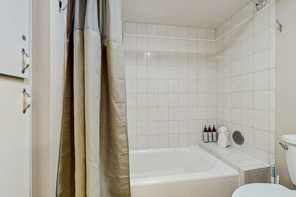 Full guest bathroom with a shower and bathtub.