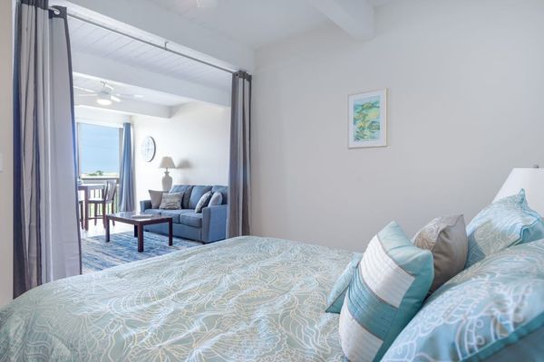Comfortable Bed, Decorative Pillows, Wall Artwork & Living Room View
