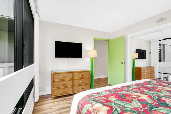 Bedroom Setup with Wall-Mounted TV & Ample Dresser Storage