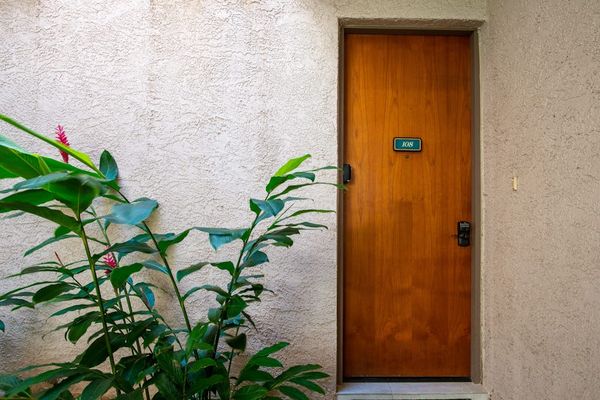 Private Front Door Entrance Framed by Tropical Red Ginger Plants