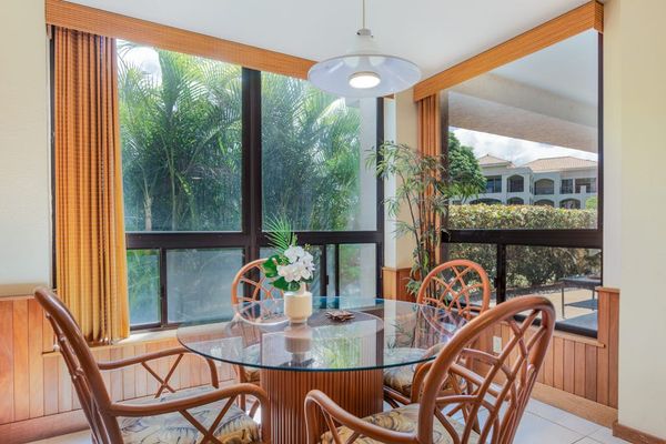 Glass-Top Dining Table Surrounded by Panoramic Garden Views