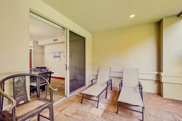 Dine at the nearby table for six, or push back the sliding glass doors and unite the indoors with the outdoors with an additional table and chairs and a wet bar with a gas grill, heating drawers, and a minifridge.