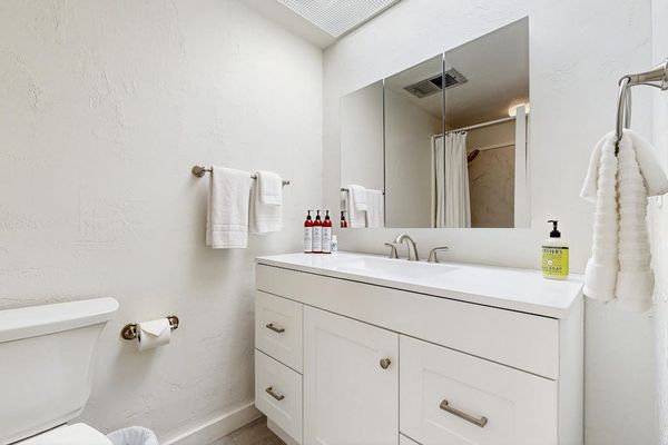 Clean Bathroom Vanity with Large Mirror & Fresh Towels