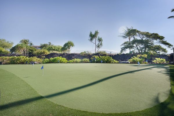 On-Site Golf Putting Green with Lush Tropical Surroundings