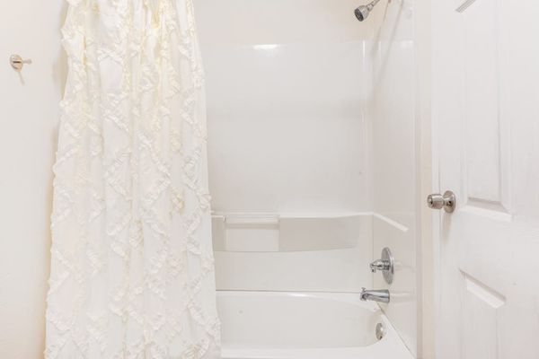 Full bathroom with tub/shower combo.