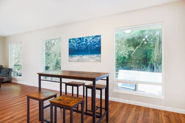 Dining room table with seating for four.  Very open feel and lots of light from the windows.