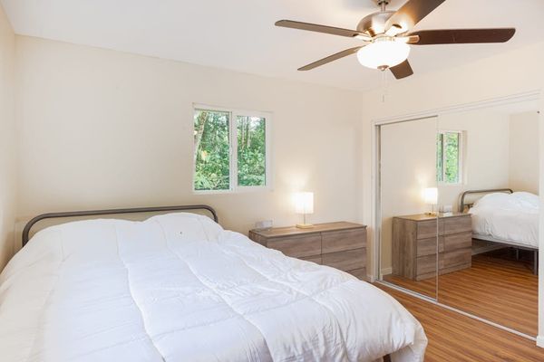 Guest room with double bed and a ceiling fan.