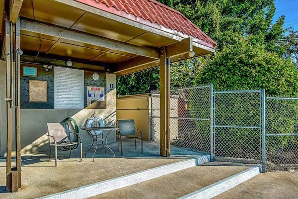 Covered Outdoor Patio with Seating and Shaded Lounging Area