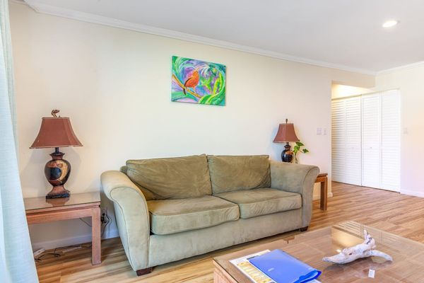 Cozy Living Room Seating Area with Comfortable Sofa, Accent Lighting, and Coffee Table