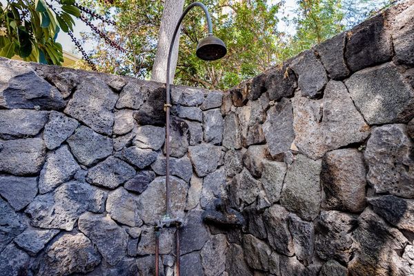 Private Outdoor Rain Shower Enclosed by Custom Natural Stone Walls