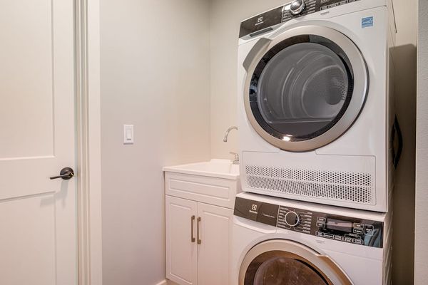 In-Unit Laundry Room with Stacked Washer, Dryer & Utility Sink