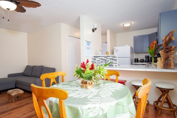 Dining room with seating for four with barstools for extra seating.