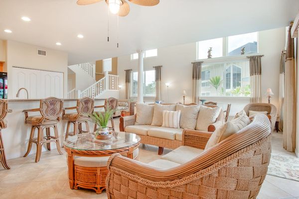 Open-Concept Living Room with Wicker Seating & Kitchen Bar View