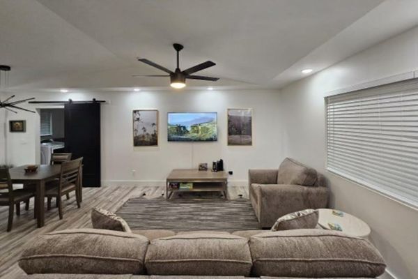Large living room with a sofa bed and a flat screen tv.  The open concept design allows for you to stay connected to everyone.