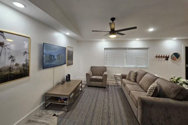 Large living room with a sofa bed and a flat screen tv.  The open concept design allows for you to stay connected to everyone.