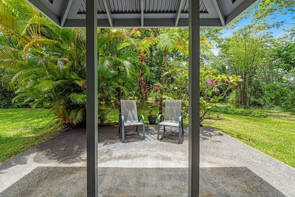 Escape to a private tropical backyard oasis surrounded by lush Hawaiian landscaping, swaying palms, and the peaceful beauty of paradise.