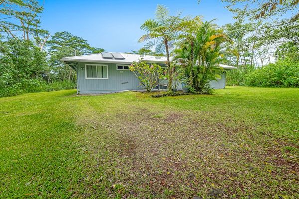 Escape to a private tropical backyard oasis surrounded by lush Hawaiian landscaping, swaying palms, and the peaceful beauty of paradise.