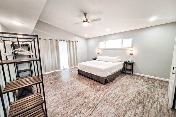 Large master bedroom with king bed and sliders to access the outside.