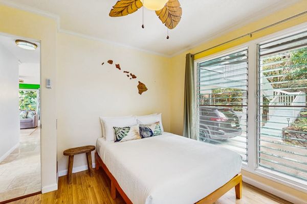 First bedroom offers queen bed natural light and balcony access