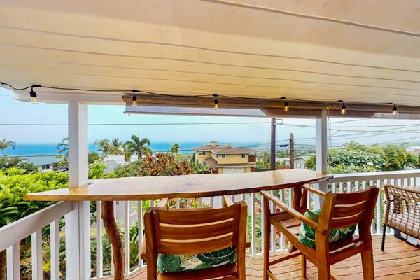 Covered balcony dining aIsland-facing balcony provides dining space and welcoming outdoor viewsrea overlooks island scenery with comfortable seating
