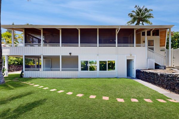 Two-Story Exterior with Upper Deck & Manicured Lawn