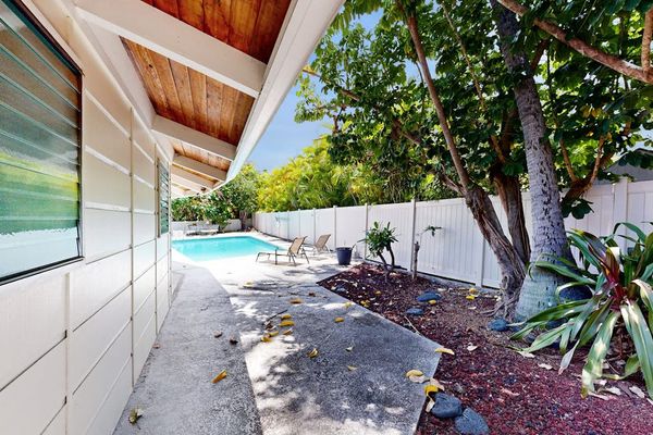 Tropical garden pathway connects home with shaded outdoor island surroundings