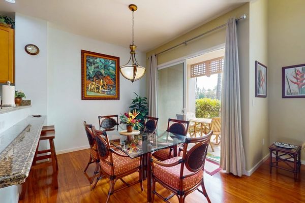 Dining room with seating for six and barstools at the connected kitchen counter for extra seating.