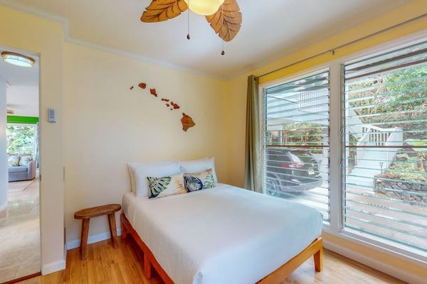 Second bedroom offers double bed bedside table and garden views