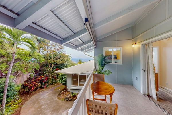 Balcony seating connects the studio with tropical outdoor views