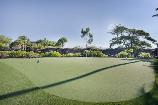 Golf Putting Green with Ocean and Mountain Background