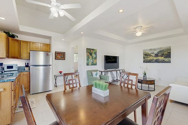 Dining room with table for four and open to the kitchen and living room.