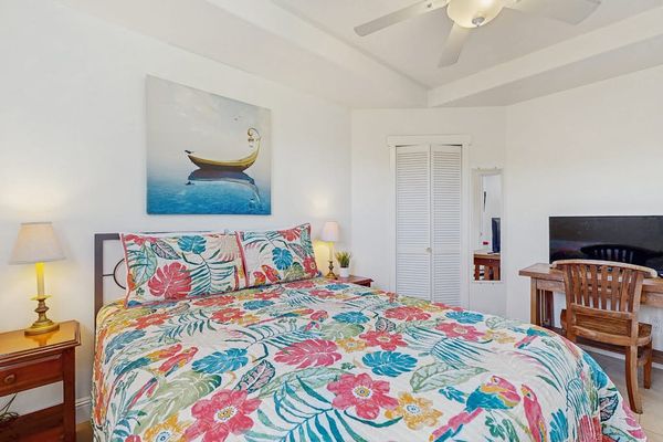 Master bedroom with queen bed with a flat screen tv.
